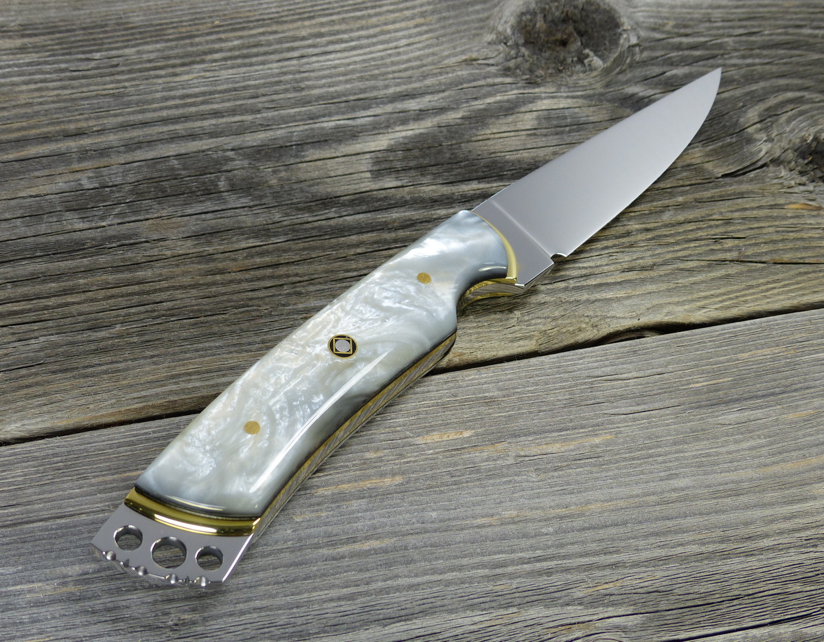 Fancy art knife with white handle and filed metal crown