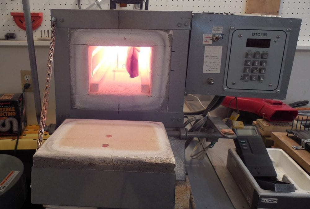 Open oven with red hot chamber showing knife blank inside