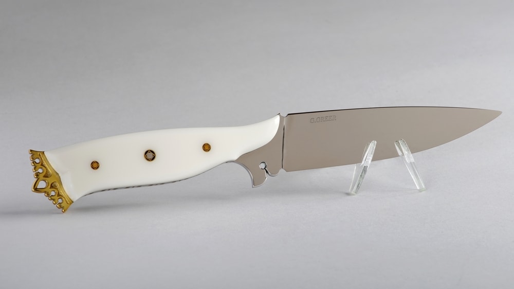 Ivory Corian art knife with sculptured brass crown and pierced ricasso