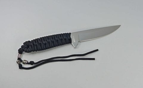 Black paracord knife with chisel grind blade