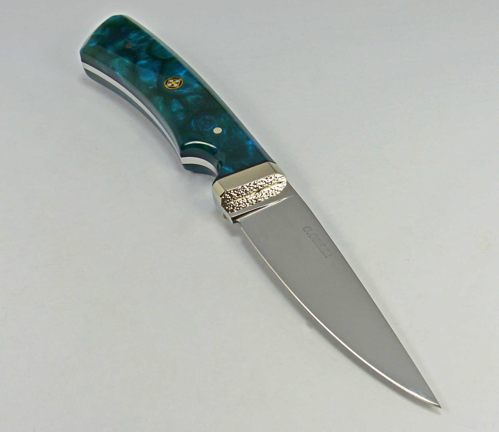 Art knife with blue pearlescent handle and dimpled guard