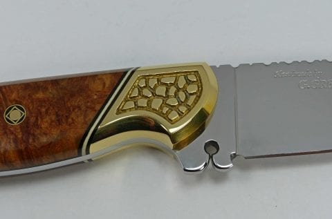 Sculptured brass bolster and pierced bottom ricasso
