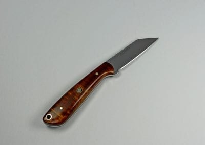Everyday carry knife with brown wood handle and sharp pointed blade
