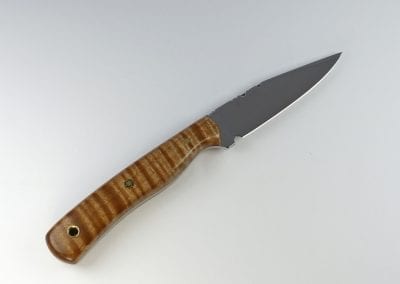 Dark striped brown handled knife with sharp pointed blade made from natural flame maple