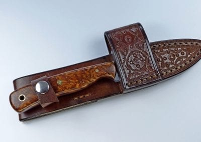 Brown everyday carry knife inside handmade leather cross draw sheath