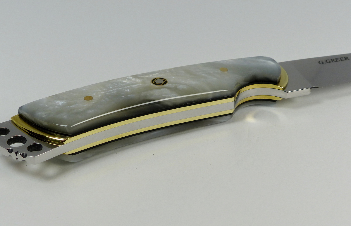 Bottom view of fancy knife showing brass and black liners - S18