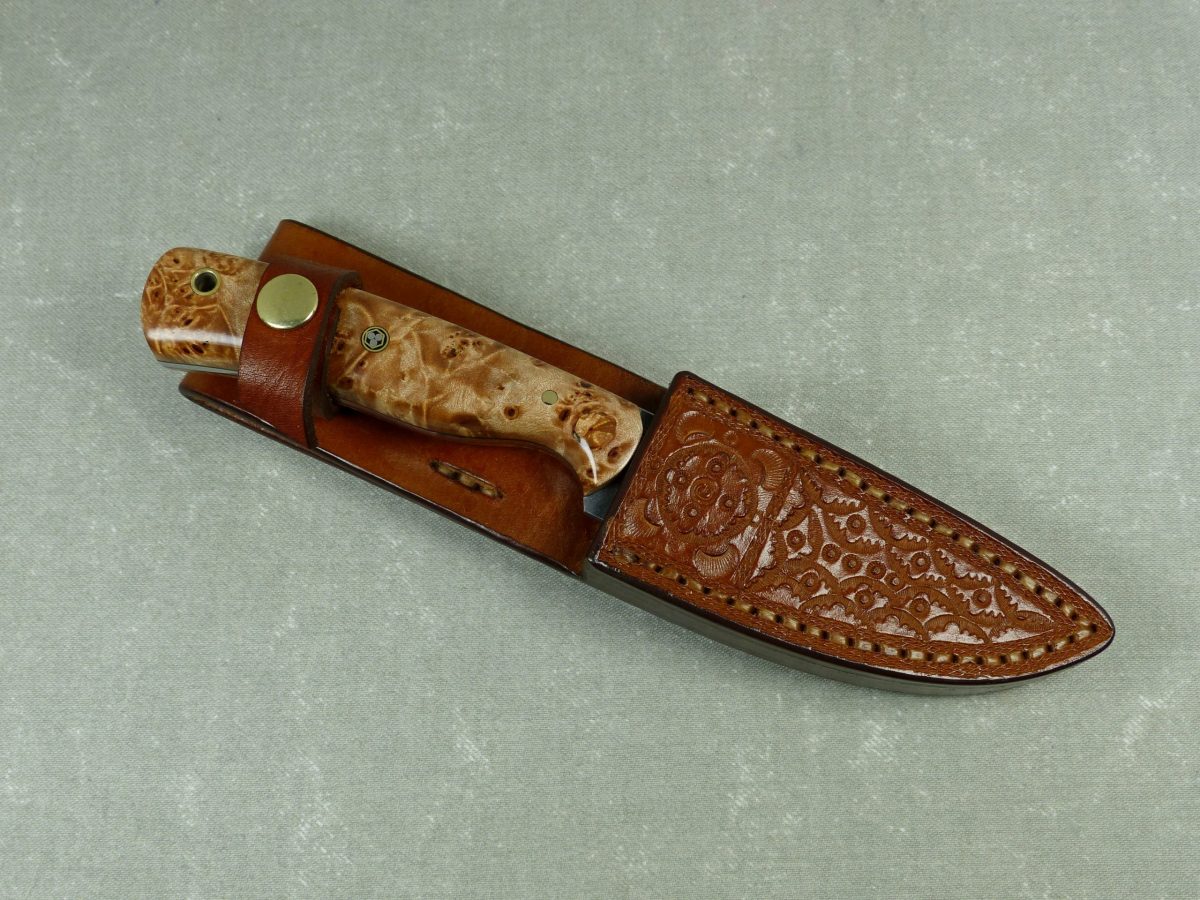 SW2 burled maple stonewashed knife inserted into handmade leather sheath