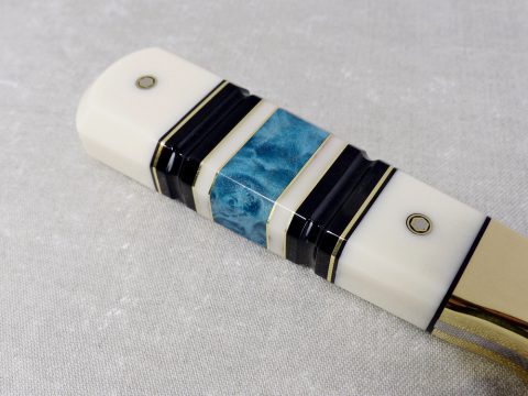 S19 Eye Candy close up of segmented wood, corian, micarta handle with brass spacers